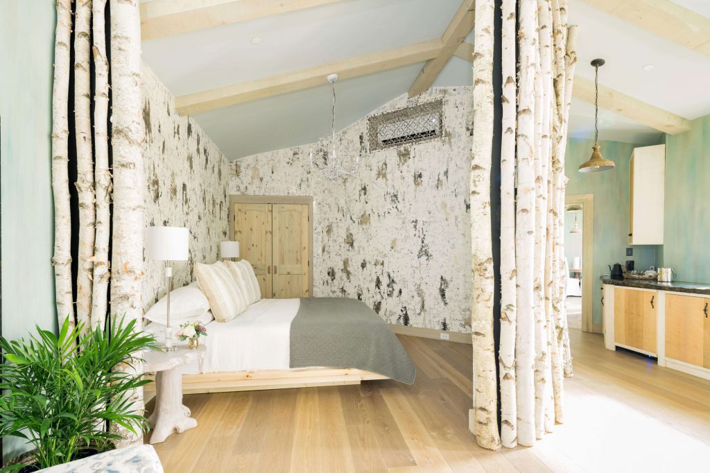 King bed enclosed in layers of Venetian plaster that mimic the feeling of a birch tree 