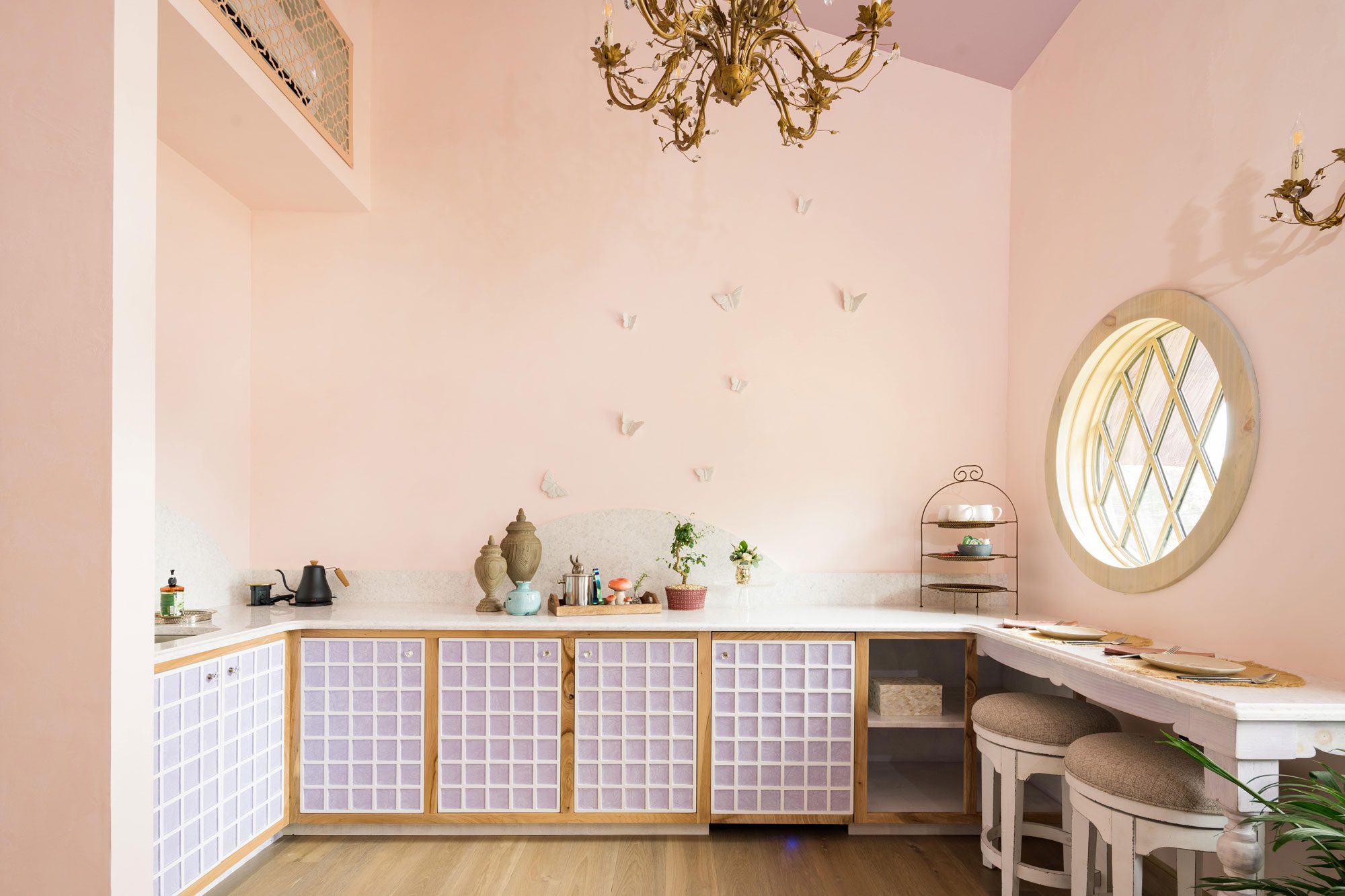 kitchen with shimmers of golds, creams, and purples embellishing the elegant, pink walls