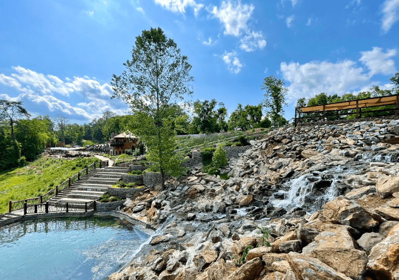 waterfall with a view of Ancient Lore Village situated in the foothills of the Smoky Mountains